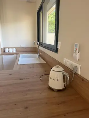 a kitchen with a toaster sitting on a wooden floor at Villa PERNOISE in Pernes-les-Fontaines