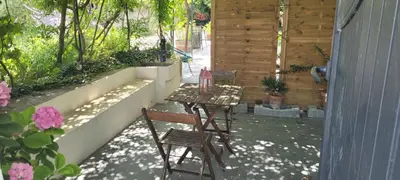 a swimming pool with chairs and a couch next to a pool at Location appartement dans mas provençal in Monteux