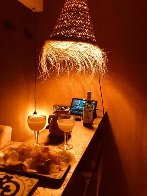 a table with glasses and a laptop and a lamp at Luberon Provence Swimming pool Terrace View for 2 in Viens
