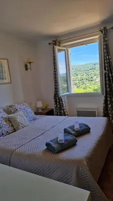 a bedroom with a bed with two towels on it at Le Jardin des Oliviers in Apt