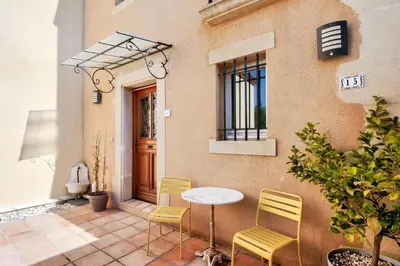 a table and chairs in front of a building at Les Mas et Villas de Pont Royal en Provence - maeva Home - Villa duplex moderne et vintage 3 pièces 6 personnes climatisée - Prestige - super Home MAE-4211 in Mallemort