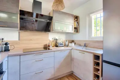 a kitchen with white cabinets and a sink at Les Mas et Villas de Pont Royal en Provence - maeva Home - Villa duplex moderne et vintage 3 pièces 6 personnes climatisée - Prestige - super Home MAE-4211 in Mallemort
