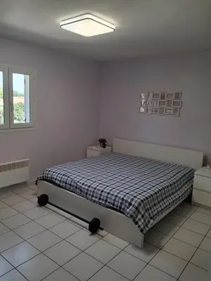 a bedroom with a bed in the corner of a room at Chez Kristina in Entraigues-sur-la-Sorgue