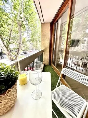 a wine glass sitting on a table on a balcony at Studio Lumineux avec Terrasse in Aix-en-Provence
