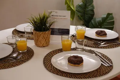 a table with plates of food and glasses of orange juice at Studio Lumineux avec Terrasse in Aix-en-Provence