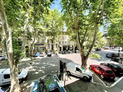 a street with cars parked in a parking lot at Studio Lumineux avec Terrasse in Aix-en-Provence