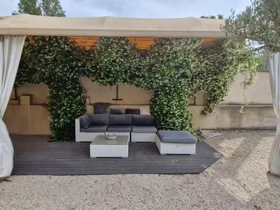 a gazebo with a couch and a table at La Villa Jasmin - RENDEZ-VOUS EN PROVENCE in Monteux