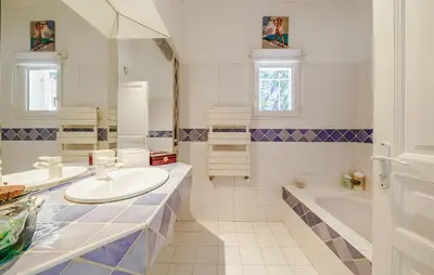 a white bathroom with a sink and a tub and a tubermott at Cozy Home In Aix-En-Provence With Wifi in Aix-en-Provence