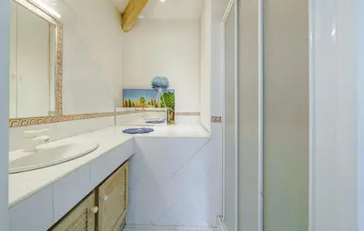 a white bathroom with a sink and a mirror at Cozy Home In Aix-En-Provence With Wifi in Aix-en-Provence