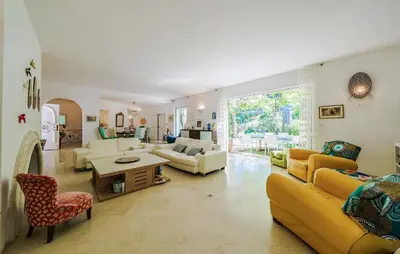 a living room with yellow couches and a table at Cozy Home In Aix-En-Provence With Wifi in Aix-en-Provence