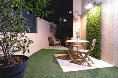 a small patio with a table and chairs on grass at Studio rénové avec belle terrasse in Aix-en-Provence