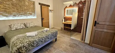 a bedroom with a bed with towels on it at Mas Les Fabrys au coeur du Luberon in Bonnieux