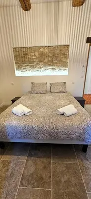a bedroom with a bed with two towels on it at Mas Les Fabrys au coeur du Luberon in Bonnieux