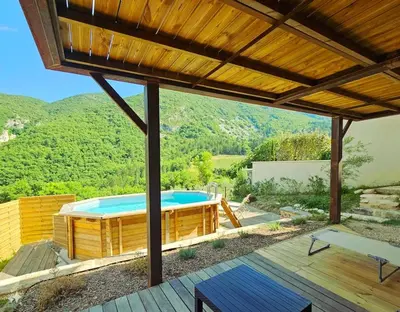 a view of a swimming pool from the deck of a house at La Castellane, vue imprenable sur le Luberon in Saignon