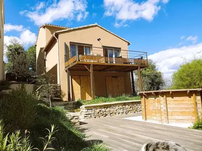 a house with a balcony on top of it at La Castellane, vue imprenable sur le Luberon in Saignon