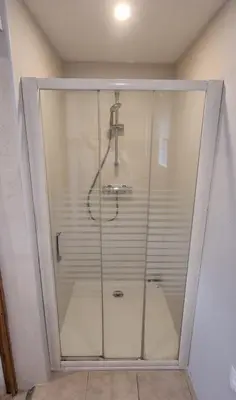 a shower with a glass door in a bathroom at La Passiflore in Mazan