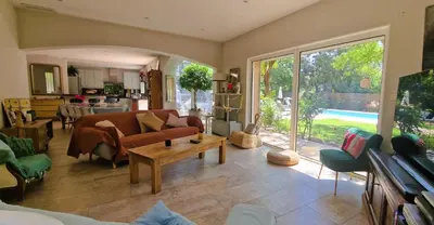 a living room with a couch and a table at La Maison du Soleil in Saint-Didier