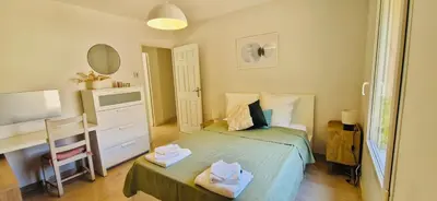 a small bedroom with a bed and a desk at La Maison du Soleil in Saint-Didier