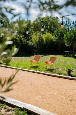two orange chairs sitting in the grass in a park at Maison Jalon in Aix-en-Provence