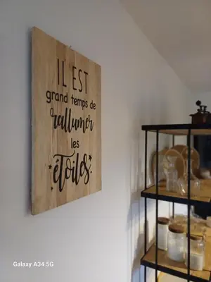 a painting hanging on a wall with a shelf at La Maison de Papé et Mamé in LʼIsle-sur-la-Sorgue