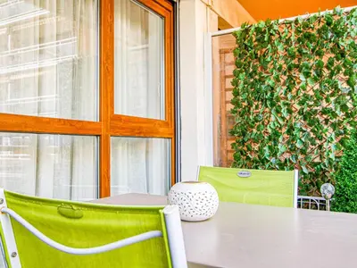 a table and chairs on a patio with a window at Apartment Chez Lucie by Interhome in Aix-en-Provence