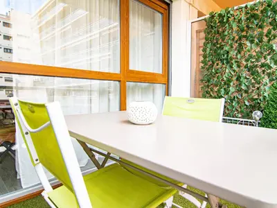 a white table with a green chair and a window at Apartment Chez Lucie by Interhome in Aix-en-Provence