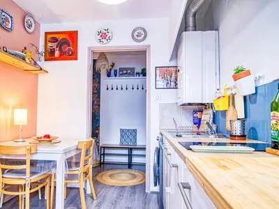 a kitchen with white cabinets and a table and chairs at Apartment Chez Lucie by Interhome in Aix-en-Provence