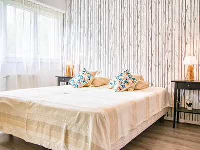 a bedroom with a white bed with pillows on it at Apartment Chez Lucie by Interhome in Aix-en-Provence