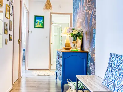a room with a blue cabinet with a vase of flowers on it at Apartment Chez Lucie by Interhome in Aix-en-Provence