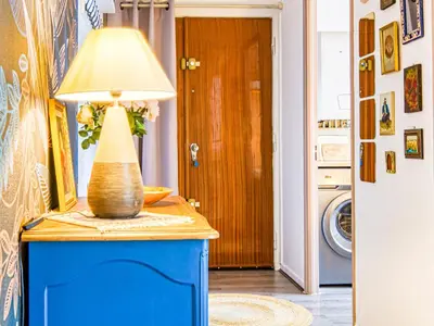 a lamp on a blue table in a room at Apartment Chez Lucie by Interhome in Aix-en-Provence