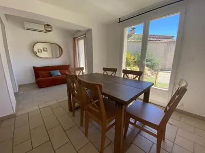 a dining room with a wooden table and chairs at La maison en couleurs 3 étoiles, du calme à 10 minutes d'Avignon in Vedène