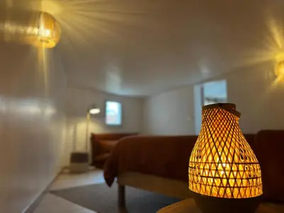 a lamp sitting on a table in a living room at La maison en couleurs 3 étoiles, du calme à 10 minutes d'Avignon in Vedène