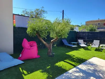a backyard with two bean bags and a tree at Pleasant detached villa with private swimming pool for 6 people in Lauris - Luberon. in Lauris