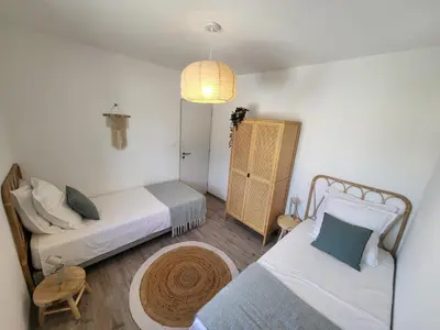 a small room with two beds and a lamp at Pleasant detached villa with private swimming pool for 6 people in Lauris - Luberon. in Lauris