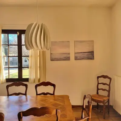 a dining room with a wooden table and chairs at Villa l'Olivier en Provence 5ch piscine jardin et clim in Lambesc