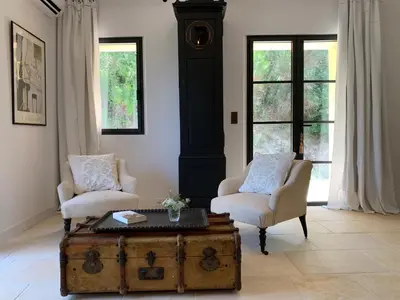 a living room with two chairs and a trunk at Côté Ansouis in Ansouis