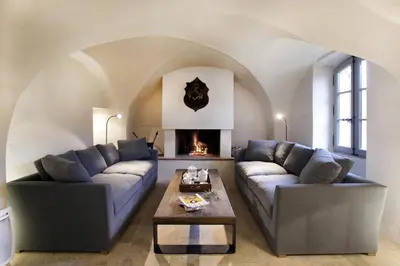 a living room with two couches and a fireplace at Domaine des Peyre in Robion en Luberon