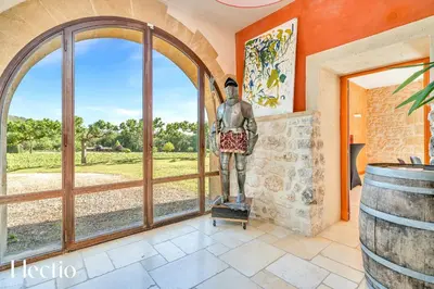 a statue of a man standing in a room with a window at Bastide Domaine Tour Campanets in Le Puy-Sainte-Réparade