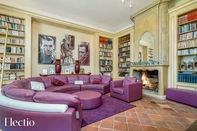 a living room with a purple couch and a fireplace at Bastide Domaine Tour Campanets in Le Puy-Sainte-Réparade