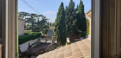 a view from a window of a yard with trees at Chambre étudiant in Morières-lès-Avignon