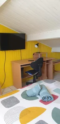 an office with a desk and a chair and a monitor at Chambre étudiant in Morières-lès-Avignon