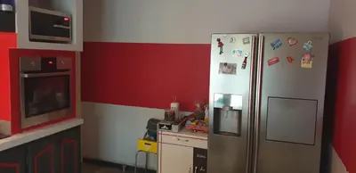 a kitchen with a stainless steel refrigerator with magnets at Chambre étudiant in Morières-lès-Avignon