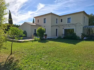 a house with a lawn in front of it at La gloriette in Saumane-de-Vaucluse