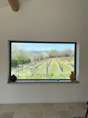 a large window with a view of a vineyard at Havre de paix sur Roussillon in Roussillon