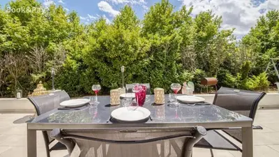 a table with glasses of wine on a patio at Villa confortable à Morières-lès-Avignon avec jardin privé in Morières-lès-Avignon