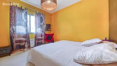a bedroom with a white bed and a yellow wall at Villa confortable à Morières-lès-Avignon avec jardin privé in Morières-lès-Avignon