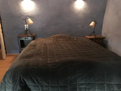 a bedroom with a bed and two lamps on two tables at maison familiale in Saint-Trinit