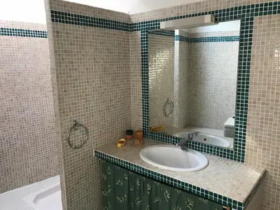 a bathroom with a sink and a mirror at maison familiale in Saint-Trinit