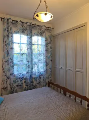 a bedroom with a large bed and a window at La Villa St Antoine in LʼIsle-sur-la-Sorgue