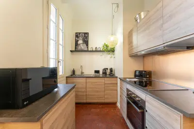 a bathroom with a shower with towels on a door at La Suite 26 - Appartement Art & Design in Aix-en-Provence